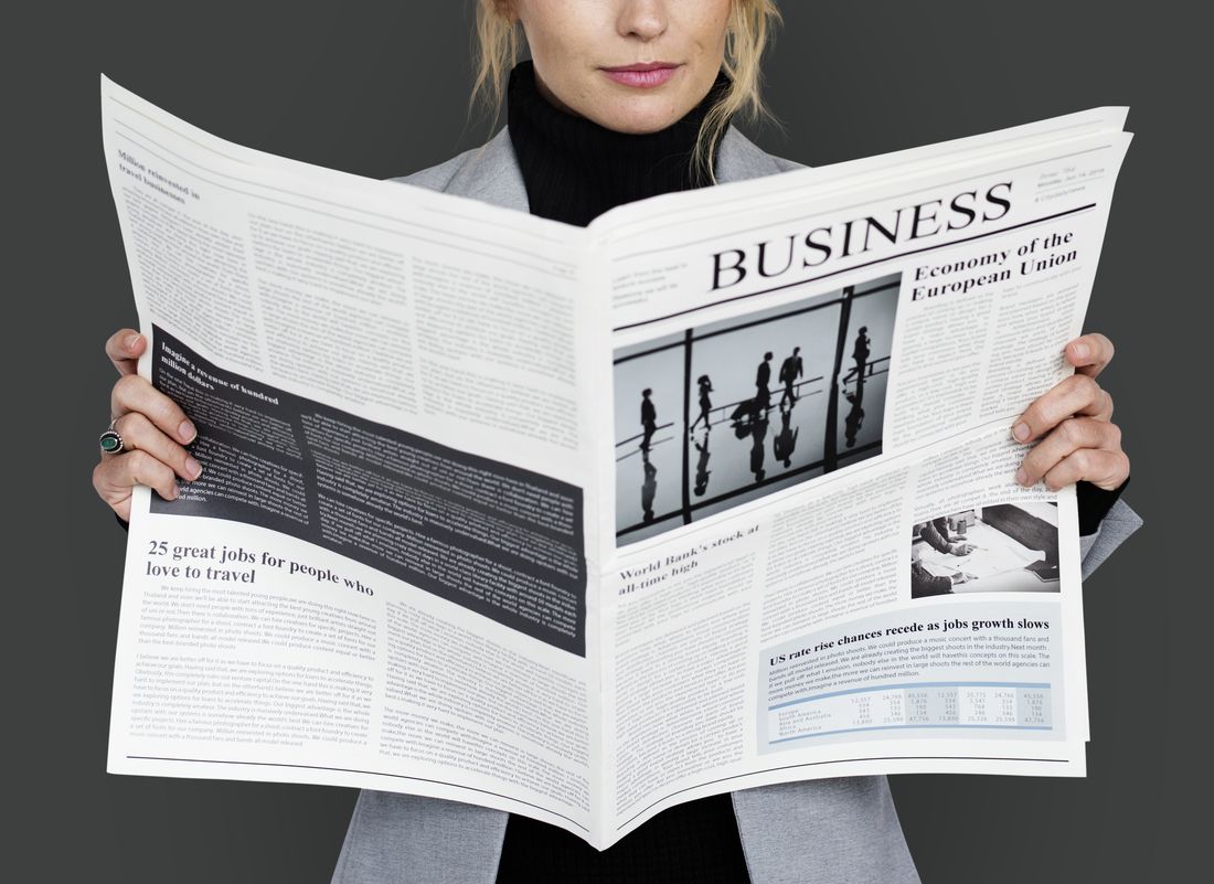 A business woman reading a newspaper