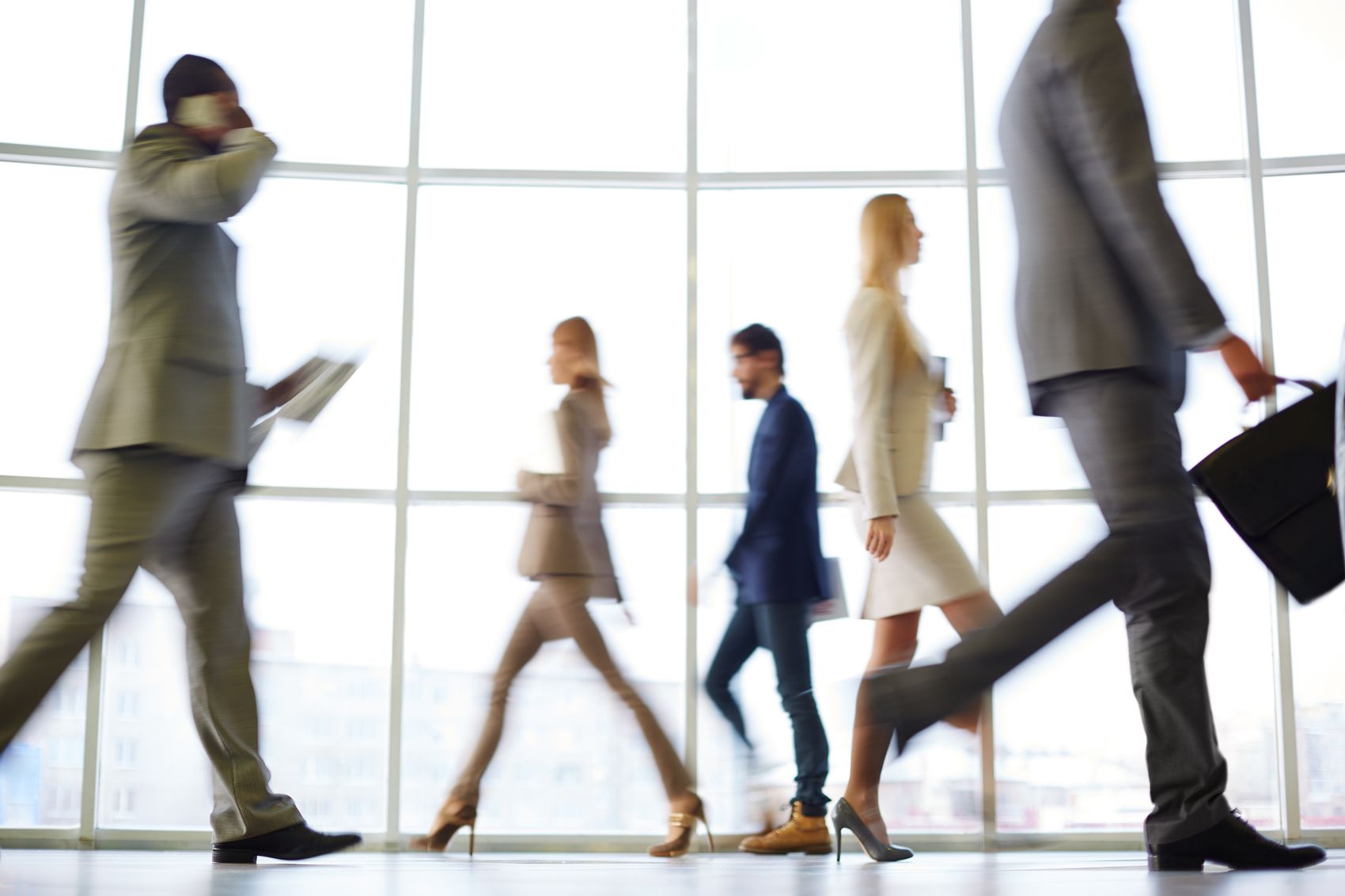 A line of positive business people standing together