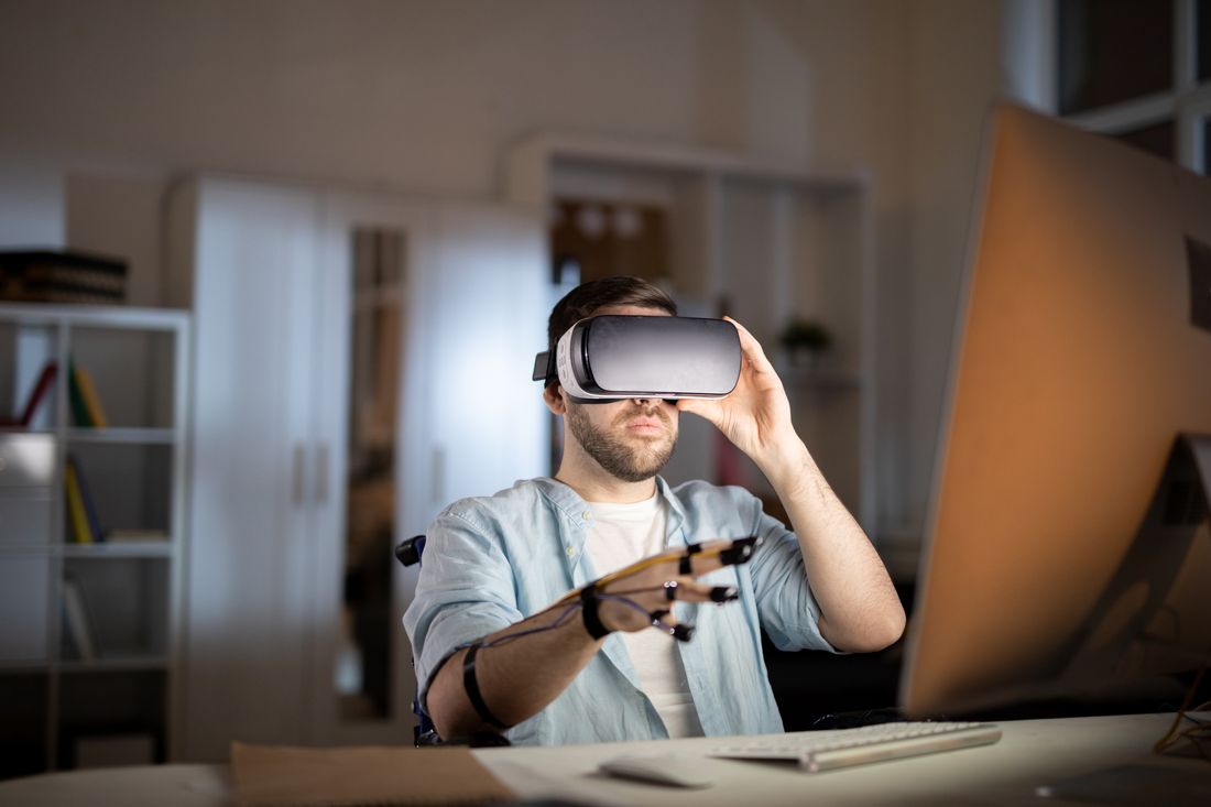 A professional using a VR headset at his desk